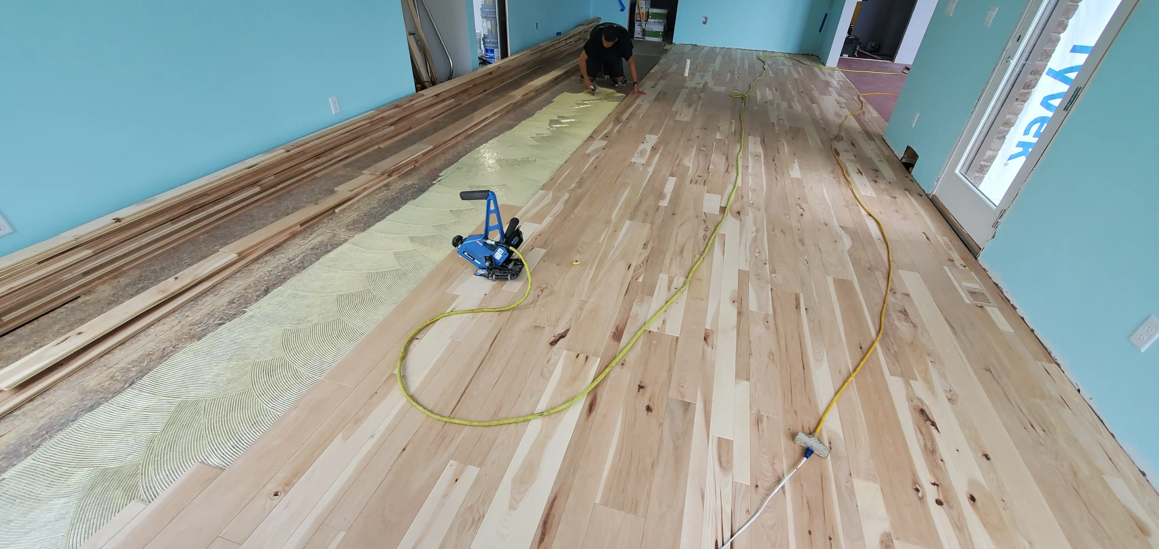 A person sanding the floor of a room.